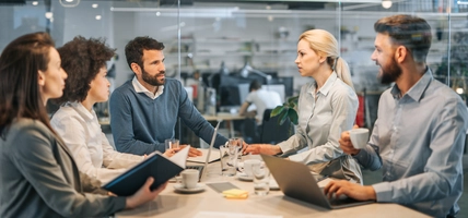 Young business colleagues communicating on a meeting in the office