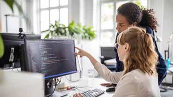 two women looking at computer screen