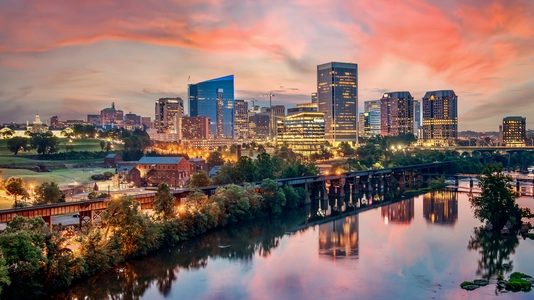 A colorful sunrise over the city of Richmond Virginia skyline and the James River.