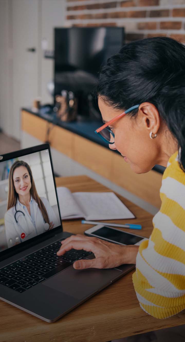 Mother trying to talk with doctor on laptop while staying at home