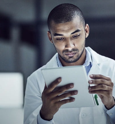 male-lab-technician-viewing-tablet