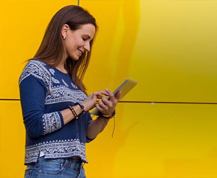 woman using smartphone yellow backdrop