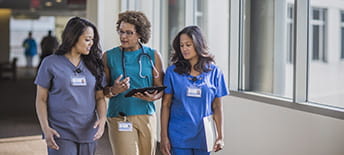 two doctors walking with hospital staff