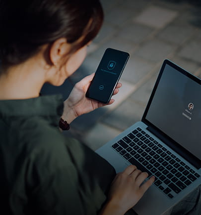 Woman using laptop and smartphone