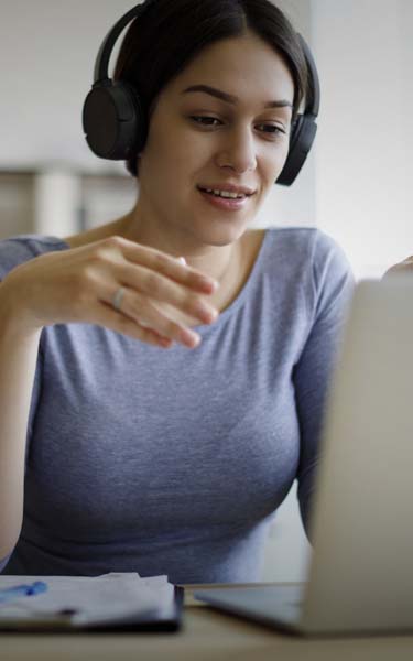 Woman wearing headphones on virtual meeting