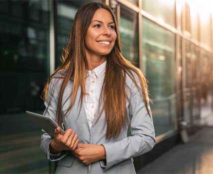 Beautiful business woman using digital tablet outdoors