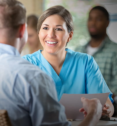 clinician in scrubs talking