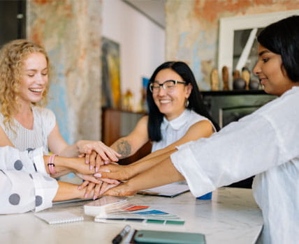 women with hands in circle