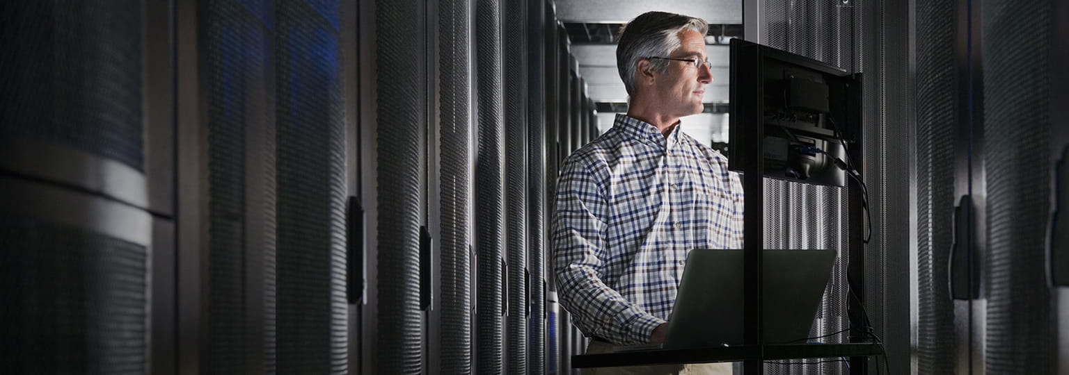 Man at computer in server room