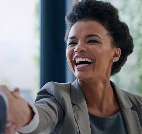 woman giving handshake while smiling