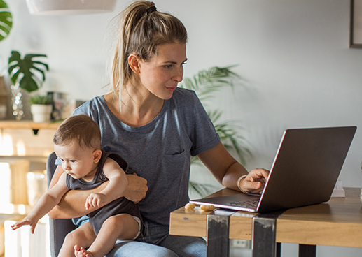 Working parent with baby on their lap