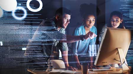 three people working on screen with digital images