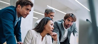 group of colleagues looking at screen