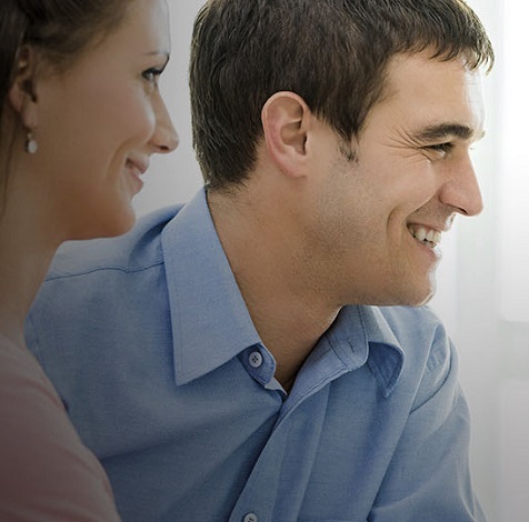 man and woman looking off happily