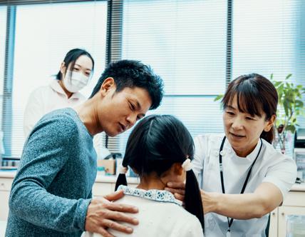 Doctor examining a young girl