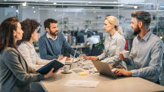 Young business colleagues communicating on a meeting in the office