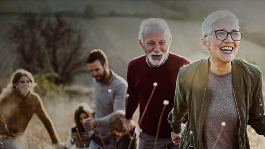 1 old couple and 1 young couple with kid in field