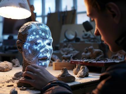 person working on model of a head with face lit up