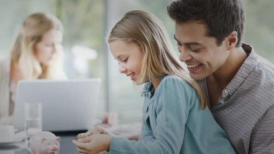 Father watching daughter count coins