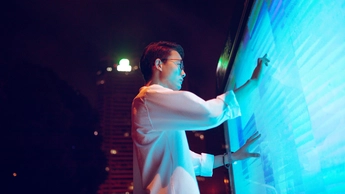 Young businessman using touch screen on the street