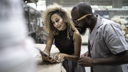 two people reviewing tablet