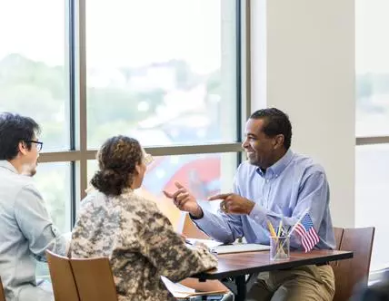 Female soldier and husband meet with loan officer