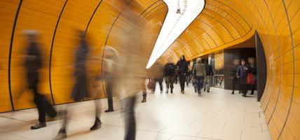 people moving quickly through orange tunnel