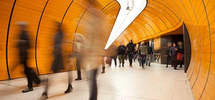 People passing by on modern orange subway