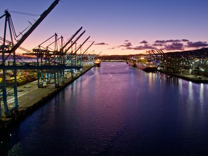 shipping boats at dock with sunset background