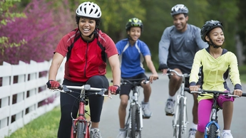 Black family riding bicycles together