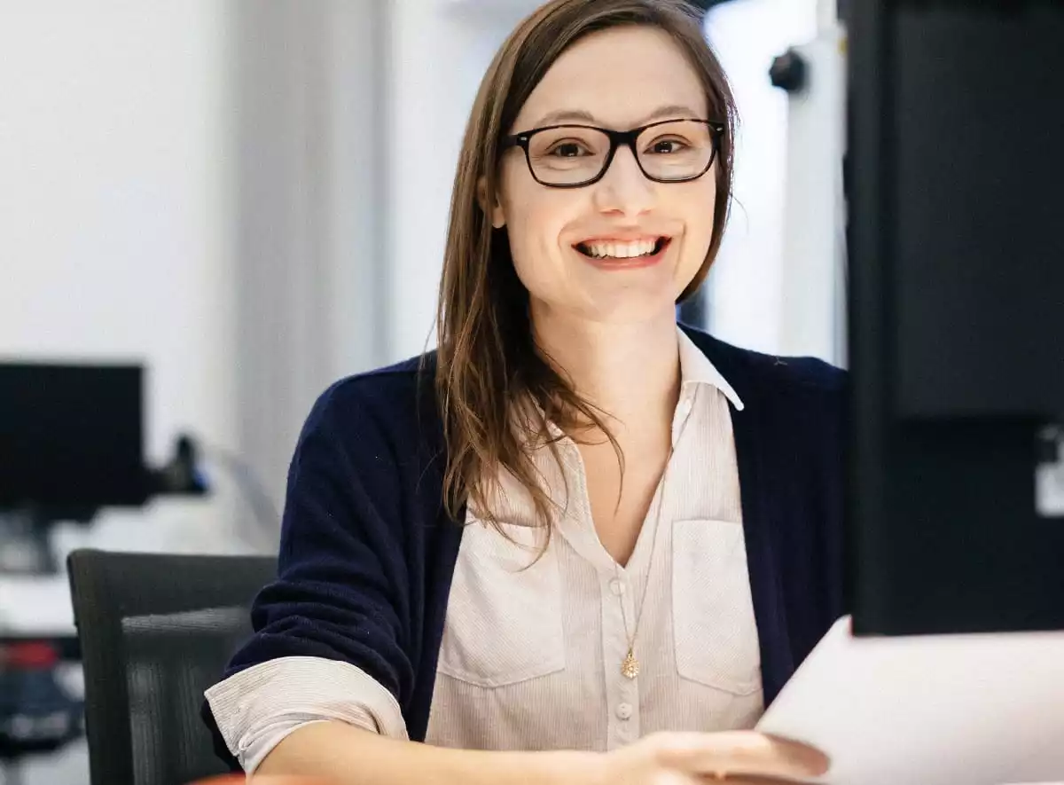 Casual busineswoman smiling at a desk in an office