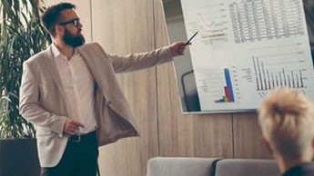 man standing in front of room presenting with screen