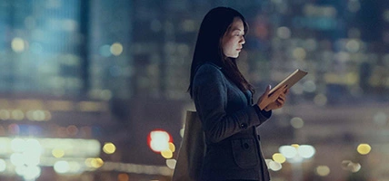 Pretty office lady is using tablet in city 